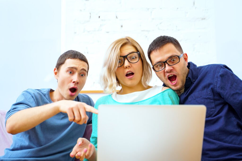 Friends sit on the couch, chatting and using a smartphone, desktop computer, laptop. Social media concept.