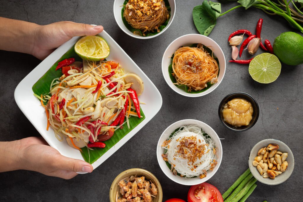 Papaya salad served with rice noodles and vegetable salad Decorated with Thai food ingredients.